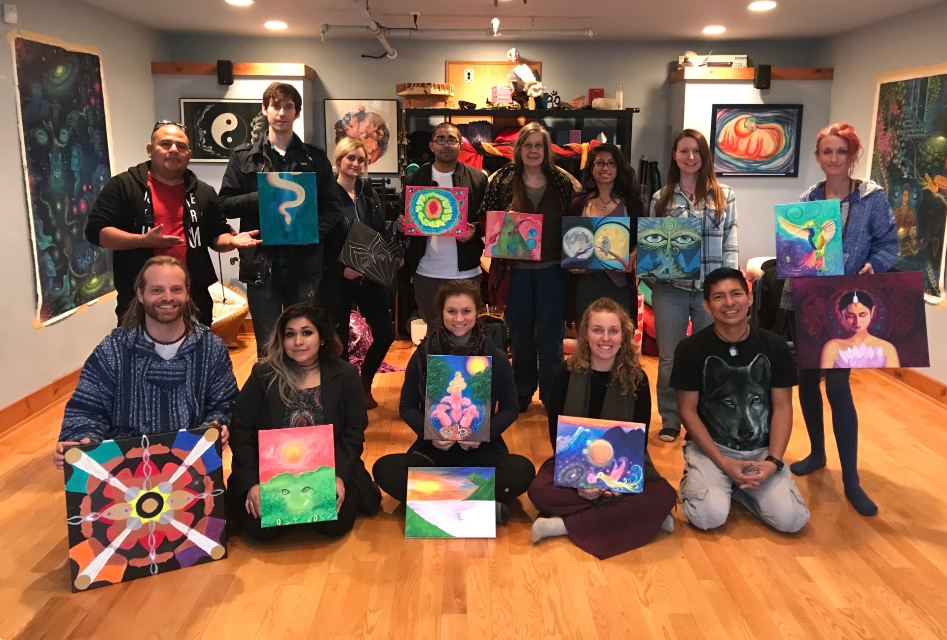 Studio workshop — small group, finished canvases in hand.